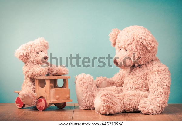 Big and small Teddy Bears, old retro toy\
wooden truck. Vintage style filtered\
photo