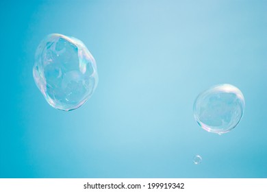 Big Soap Bubbles On The Blue Sky