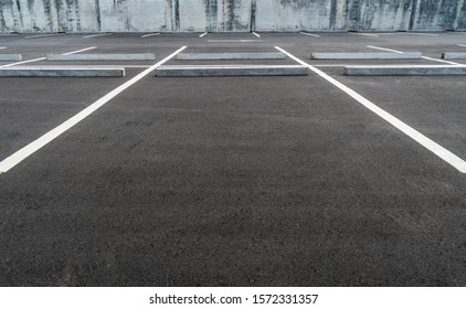 Big Space At Empty Asphalt Parking Lot With Concrete Car Stopper, Perspective And Low Angle View.