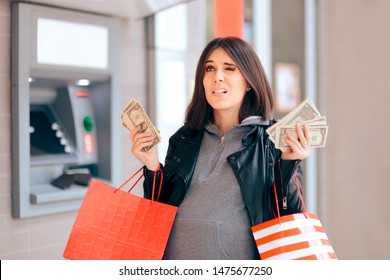 Big Spender Holding Money In Front Of The ATM. Woman Buying Baby Stuff With Cash Maternity Allowance 
