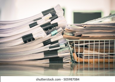 Big Stack Of Business Report Paper Files With Black Clips

