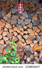 Big stack of chopped firewood and red lantern