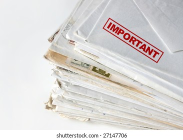 Big Stack Of Letters And Envelopes On A Desk, Top Letter Labeled As Important.