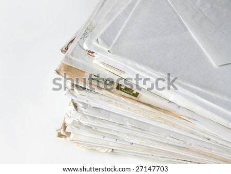 Big stack of letters and envelopes on a desk.