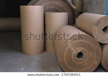 Big Stack of Printing Paper Rolls in Warehouse. The concept of production of paper and paperboard.