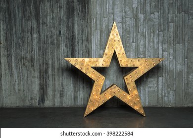 Big Star. Star object is on the floor against the backdrop of a concrete wall.