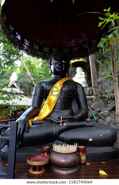Big\
statue black buddha in Wat Chaloem Phra Kiat Phrachomklao\
Rachanusorn located on Doi Pu Yak place in\
Lampang
