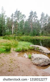 Big stone is in the lake in Finland at summer. - Shutterstock ID 1318312277