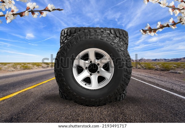 Big strong car tires with a great\
profile in the car repair shop.  Set o winter tires on\
road.