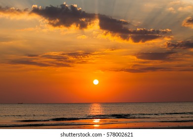 Big Sun Setting Down Over The Sea, The Red Disc Of The Sun Touches The Horizon In The Ocean.