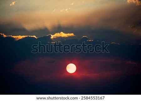 Big sun. Sunset sky dramatic sun clouds and sunset sunrays. Beautiful colorful dramatic sun with clouds at sunset or sunrise. Sun rays. Skyscape nature composition. Natural sky background.