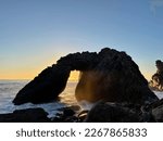 Big Sur Kirk Creek Campground ocean front beach hole in rock with sunset and waves crashing California Coast highway 1 orange pink purple blue sky
