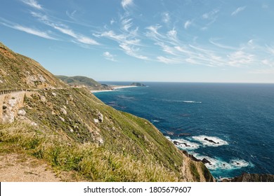 Big Sur Road Trip. Scenic California State Route 1. Rocky Cliffs With Native Plants, And Beautiful Turquoise Colored Pacific Ocean.