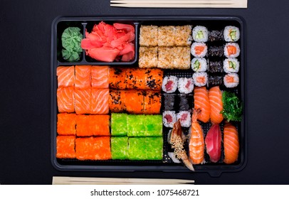 Big Sushi Set Ib Black Plastic Box On Black Background/ Top View Close Up Macro Shoot