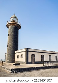 Big Tall Stone Lighthouse On A Blue Sky Background. No People. Nature Wallpaper. 