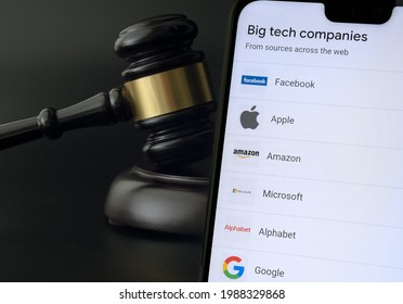 Big Tech tax regulation concept. Smartphone with the list of companies (Google definition of Big Tech) placed next to the judge gavel. Stafford, United Kingdom, July 7, 2021.