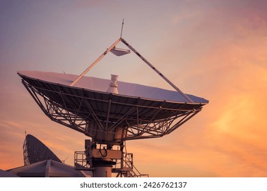 Big telecommunication  satellite dish or Radio Telescope in evening with twilight sky at dusk.