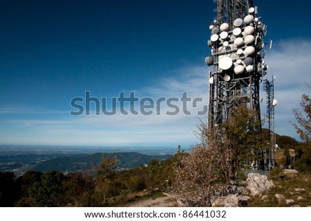 Big television and radio tower with several parabolic antenna on high quote (mountain) - Roncola (Italy)