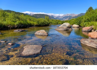 Big Thompson River - Summer blue sky reflected in clear and calm Big Thompson River in Moraine Park of Rocky Mountain National Park, Colorado, USA. - Powered by Shutterstock