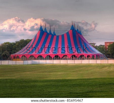 big top circus tent on a field in a park, built up for a music festival