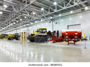 Big tractors are in room at exhibition, special agricultural machines