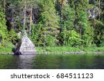 Big triangle rock on lakeshore in Lake Pettama, Jamsa, Finland