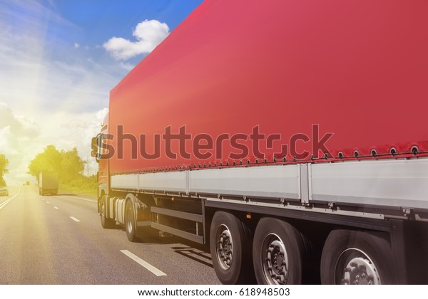 big truck goes on\
the highway to sunrise