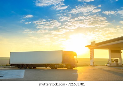 Big Truck Rides To The Gas Station, In The Background Sunrise