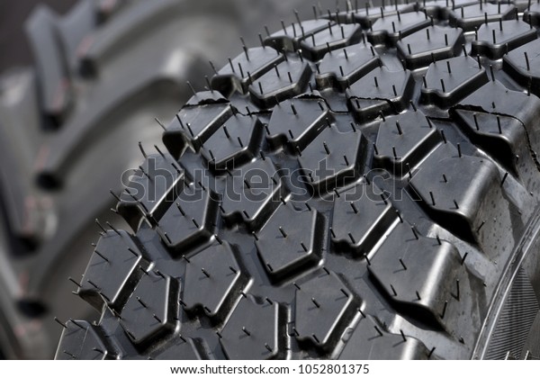 Big truck or
tractor wheel a black tires
closeup
