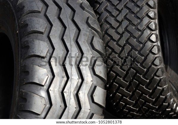 Big truck or\
tractor wheel a black tires\
closeup