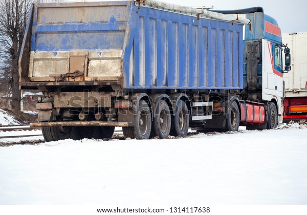 big truck with a trailer\
in the snow
