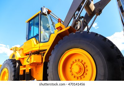 Big Truck Wheel Closeup Object. Bulldozer Closeup Wheels Sky Sunny Summer