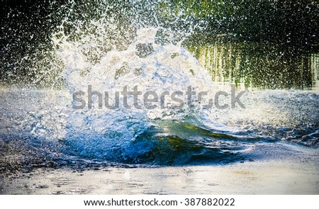 big water splash in lake after diving. Splash water on the river, beautiful colorful, bright splash