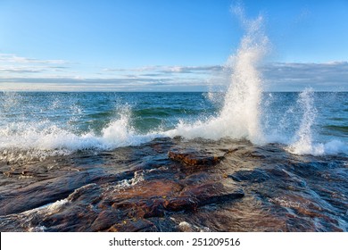 Big Wave Splash On Lake Superior In The Upper Peninsula Of Michigan. Waves Break Against A Rocky Shoreline Near Pictured Rocks National Lakeshore Near Munising