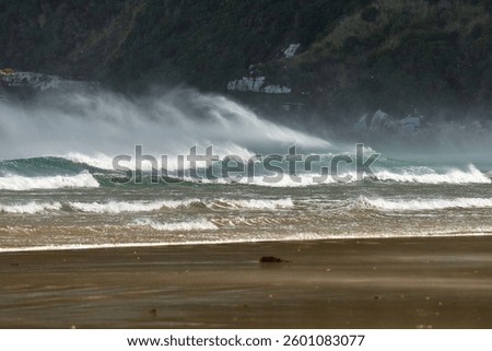 Big waves breaking in the wind, stormy gust
