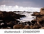 Big waves crashing on rocks by the coast in California