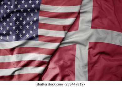 big waving colorful flag of united states of america and national flag of denmark . macro