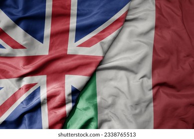 big waving national colorful flag of great britain and national flag of italy . macro