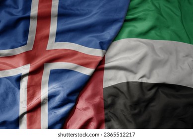 big waving national colorful flag of icelandic and national flag of united arab emirates . macro
