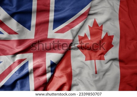 big waving national colorful flag of great britain and national flag of canada . macro
