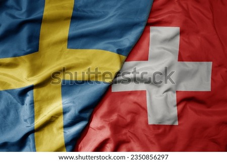 big waving national colorful flag of sweden and national flag of switzerland . macro