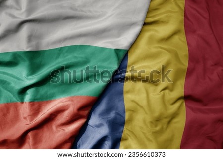 big waving national colorful flag of bulgaria and national flag of romania . macro