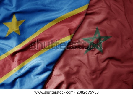big waving national colorful flag of democratic republic of the congo and national flag of morocco . macro