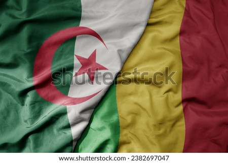 big waving national colorful flag of algeria and national flag of mali . macro