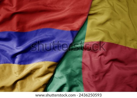 big waving national colorful flag of benin and national flag of armenia . macro