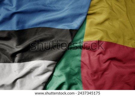 big waving national colorful flag of benin and national flag of estonia. macro