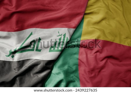 big waving national colorful flag of benin and national flag of iraq. macro
