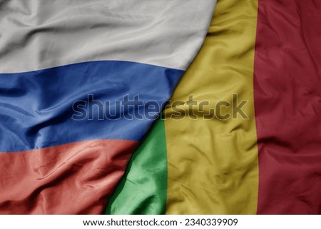 big waving realistic national colorful flag of russia and national flag of mali . macro