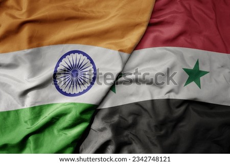 big waving realistic national colorful flag of india and national flag of syria . macro
