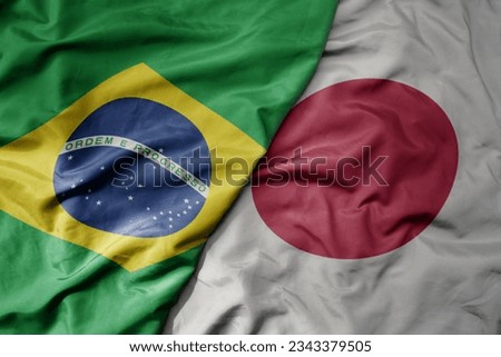 big waving realistic national colorful flag of brazil and national flag of japan . macro